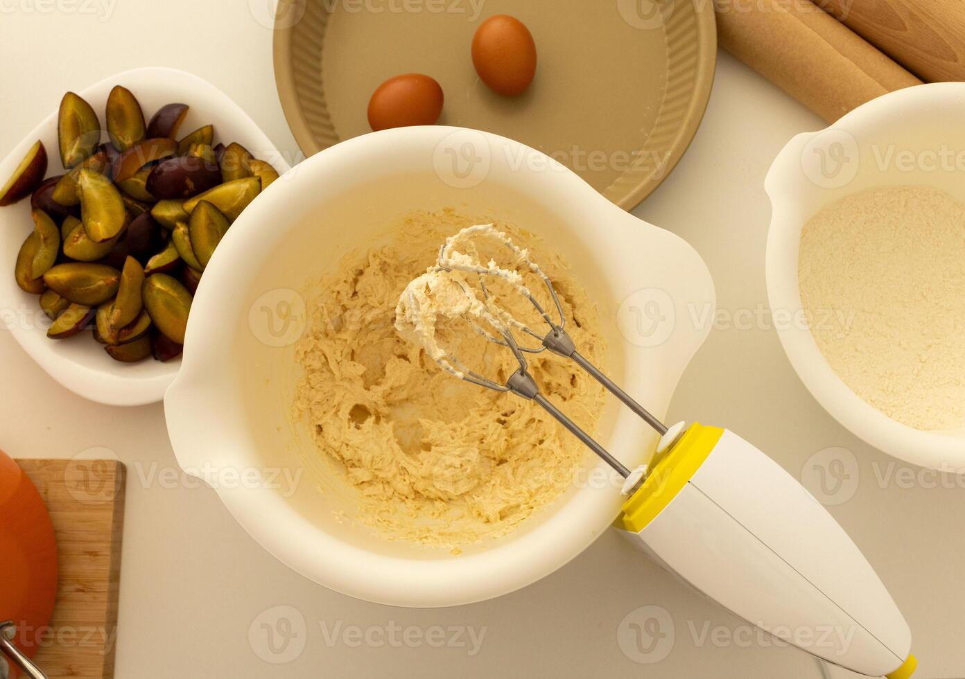 whipped plum pie batter in white bowl, cooking at home photo