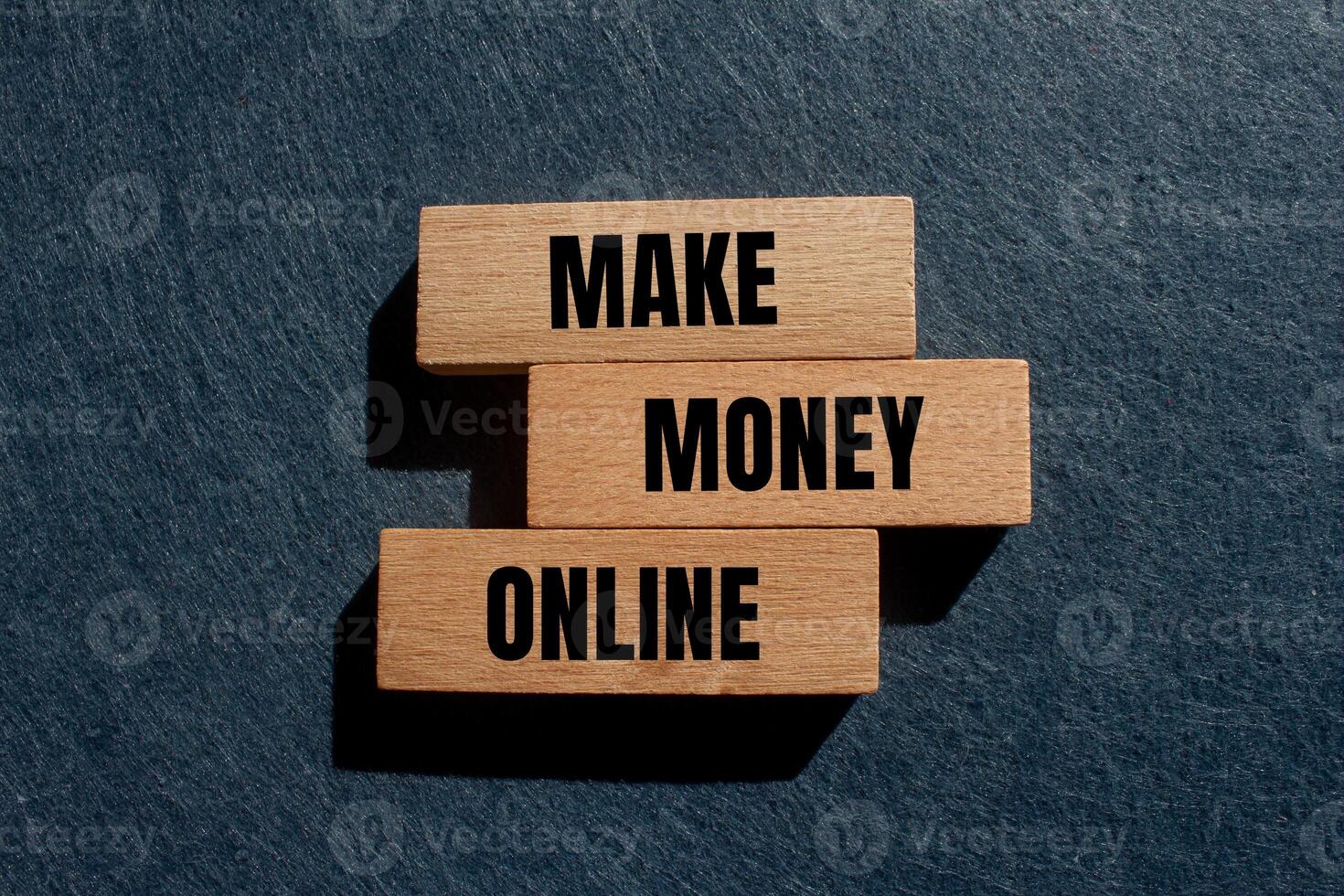 Make money online message written on wooden blocks with gray background. Conceptual make money online symbol. Copy space. photo
