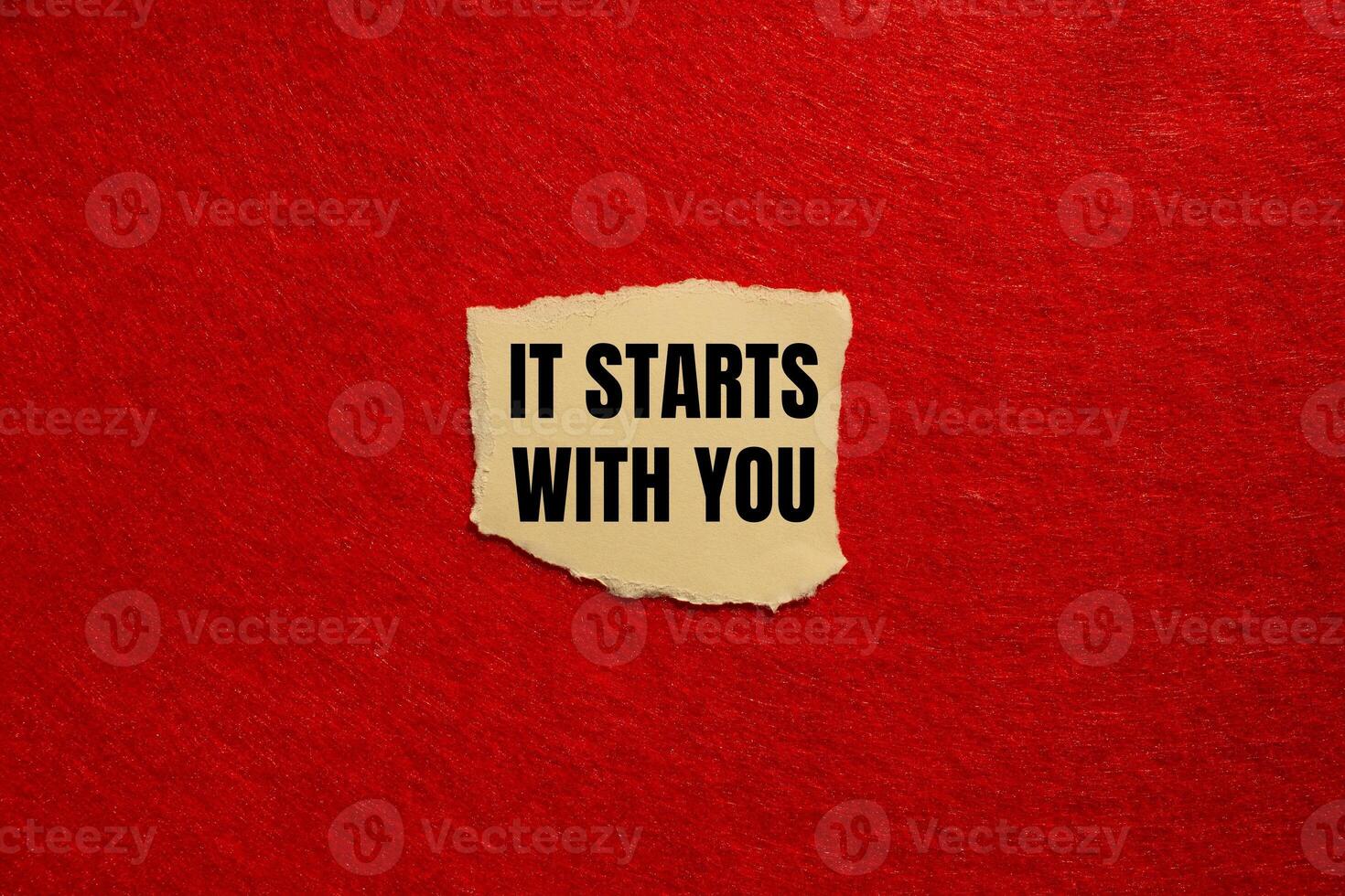 It starts with you message written on ripped torn paper piece with red background. Conceptual it starts with you symbol. Copy space. photo