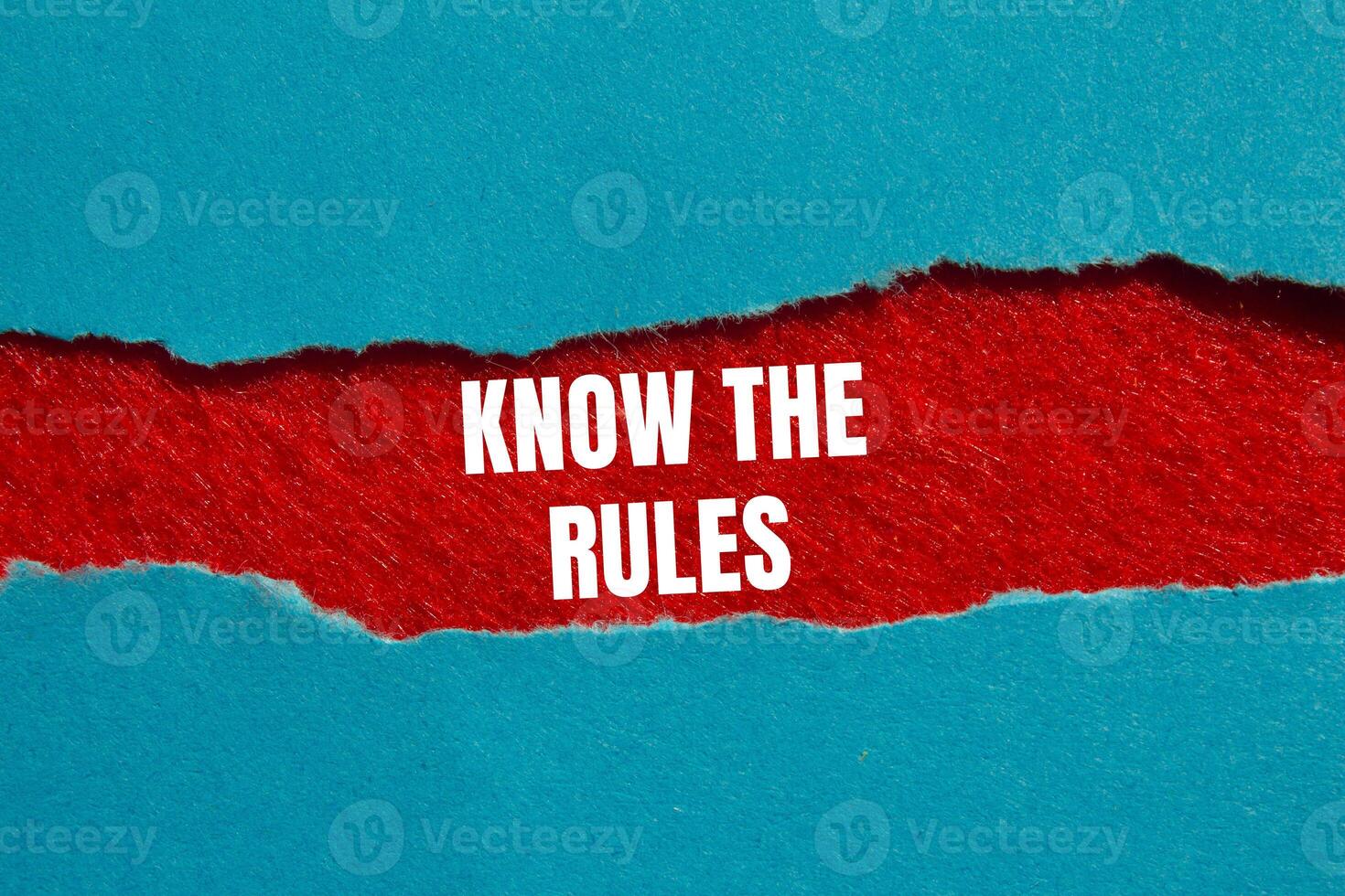 Know the rules message written on ripped torn blue paper on red background. Conceptual know the rules symbol. Copy space. photo