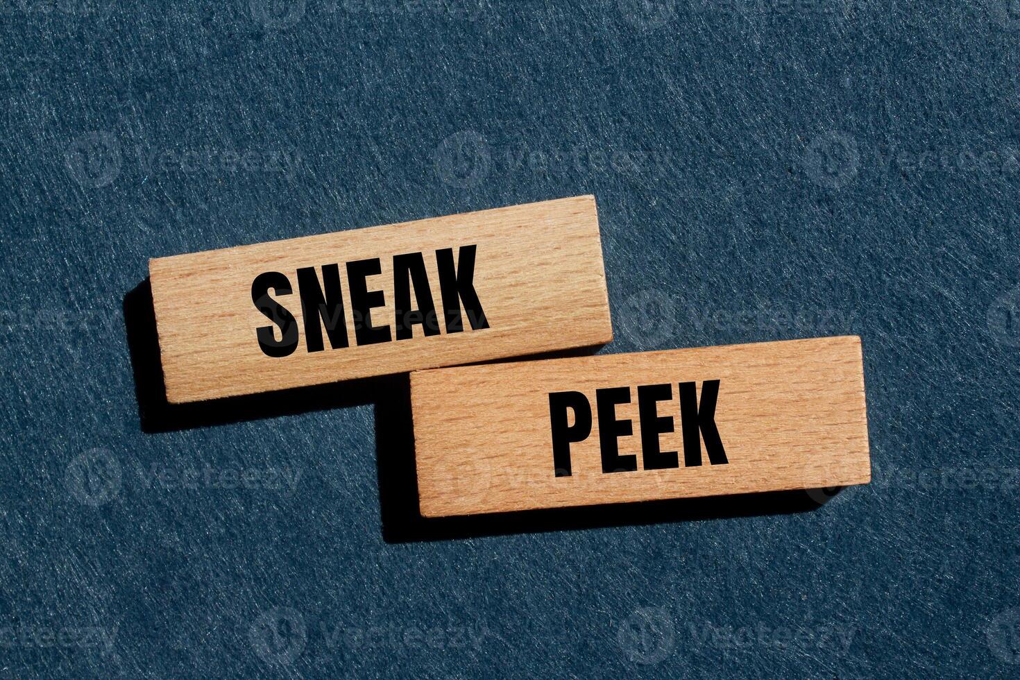 Sneak peek message written on wooden blocks with gray background. Conceptual sneak peek symbol. Copy space. photo
