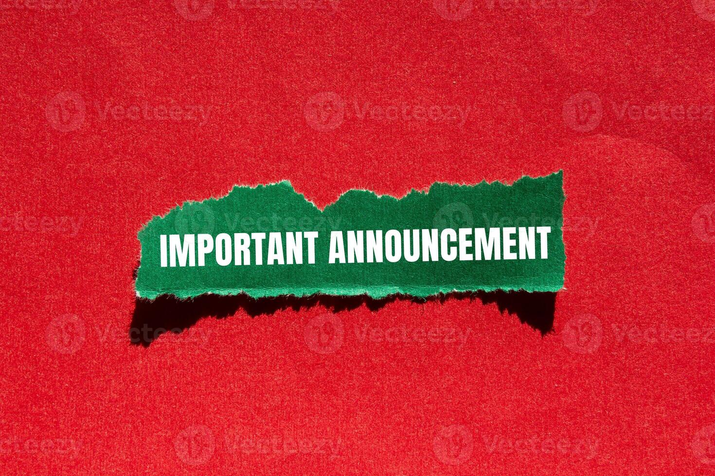 Important announcement message written on ripped torn green paper piece with red background. Conceptual important announcement symbol. Copy space. photo