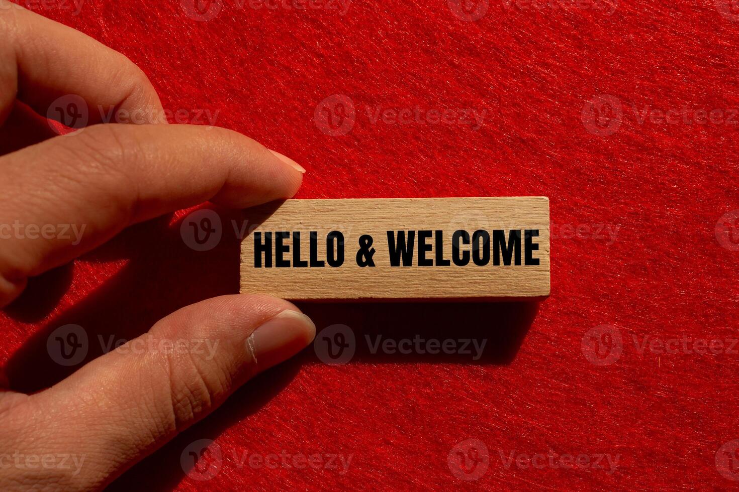 Hello and welcome message written on wooden block with red background. Conceptual hello and welcome symbol. Copy space. photo