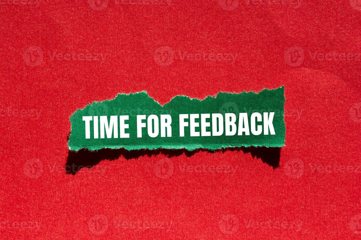 Time for feedback message written on ripped torn green paper piece with red background. Conceptual time for feedback symbol. Copy space. photo