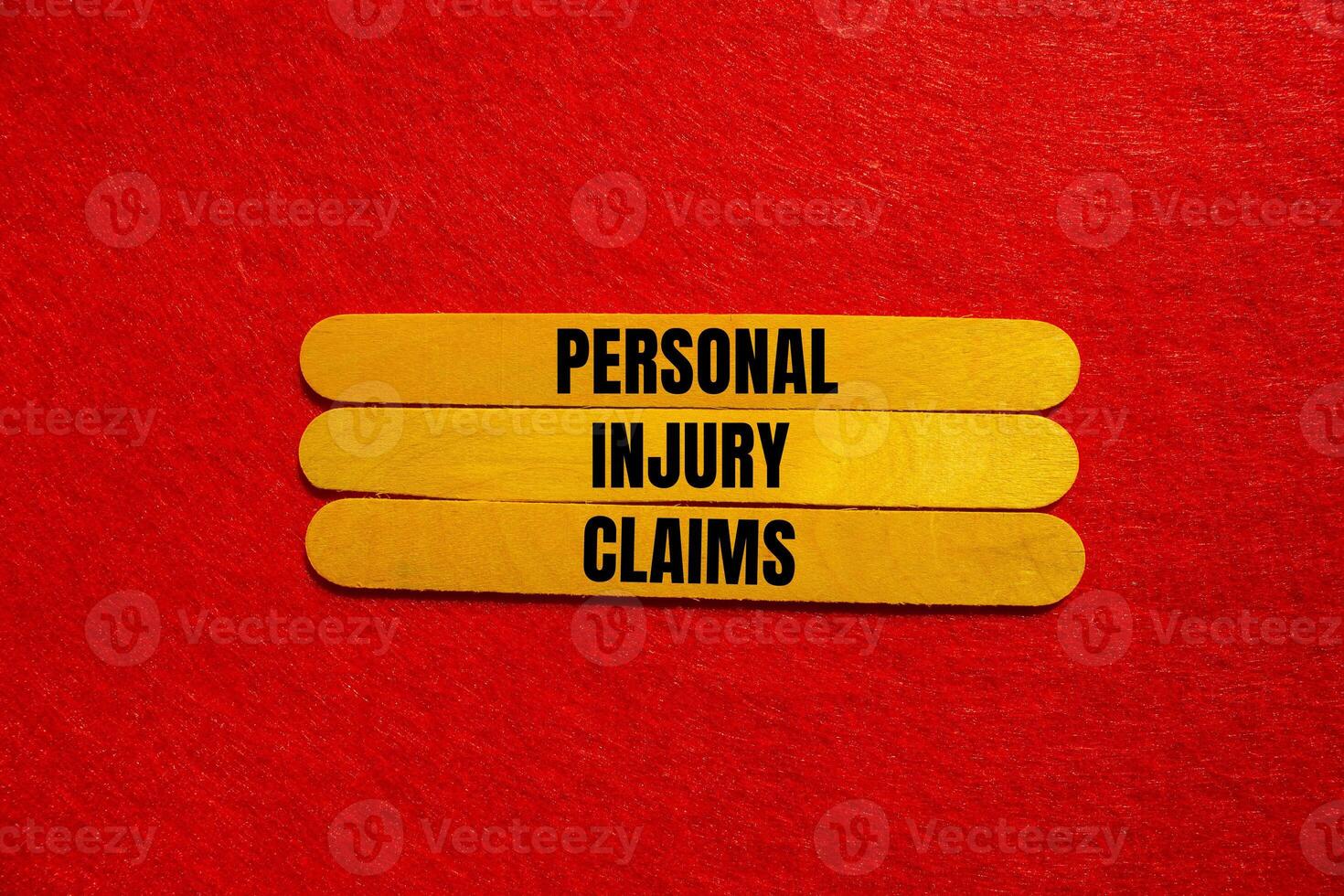 Personal injury claims message written on yellow wooden sticks with red background. Conceptual personal injury claims symbol. Copy space. photo