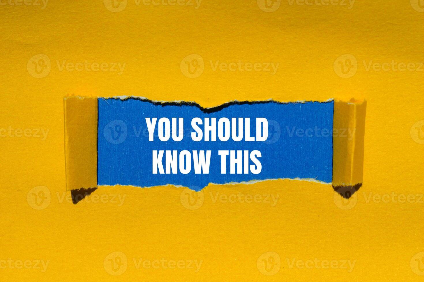 You should know this message written on ripped torn yellow paper with blue background. Conceptual you should know this symbol. Copy space. photo