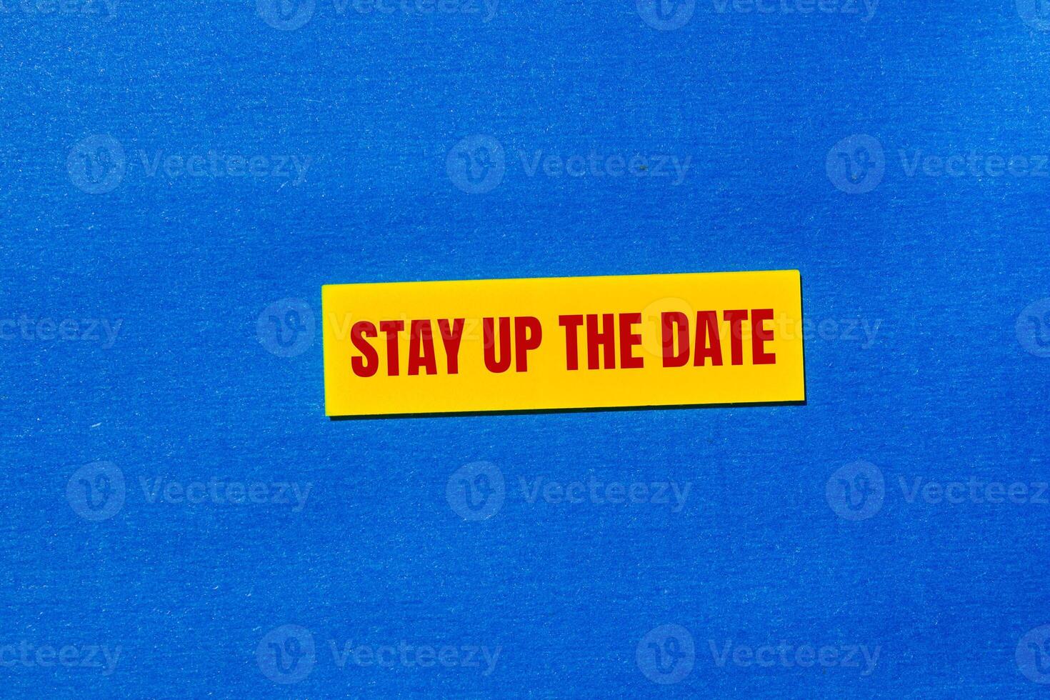 Stay up the date message written on yellow sticker with blue background. Conceptual stay up the date symbol. Copy space. photo