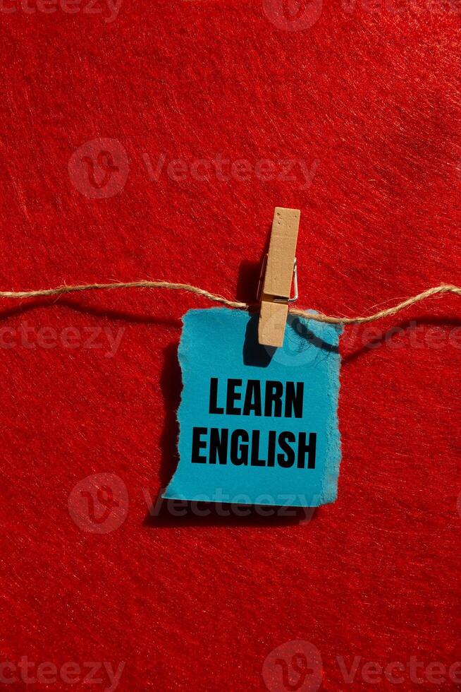 Latest news message written on ripped torn blue paper piece with red background. Conceptual latest news symbol. Copy space. photo