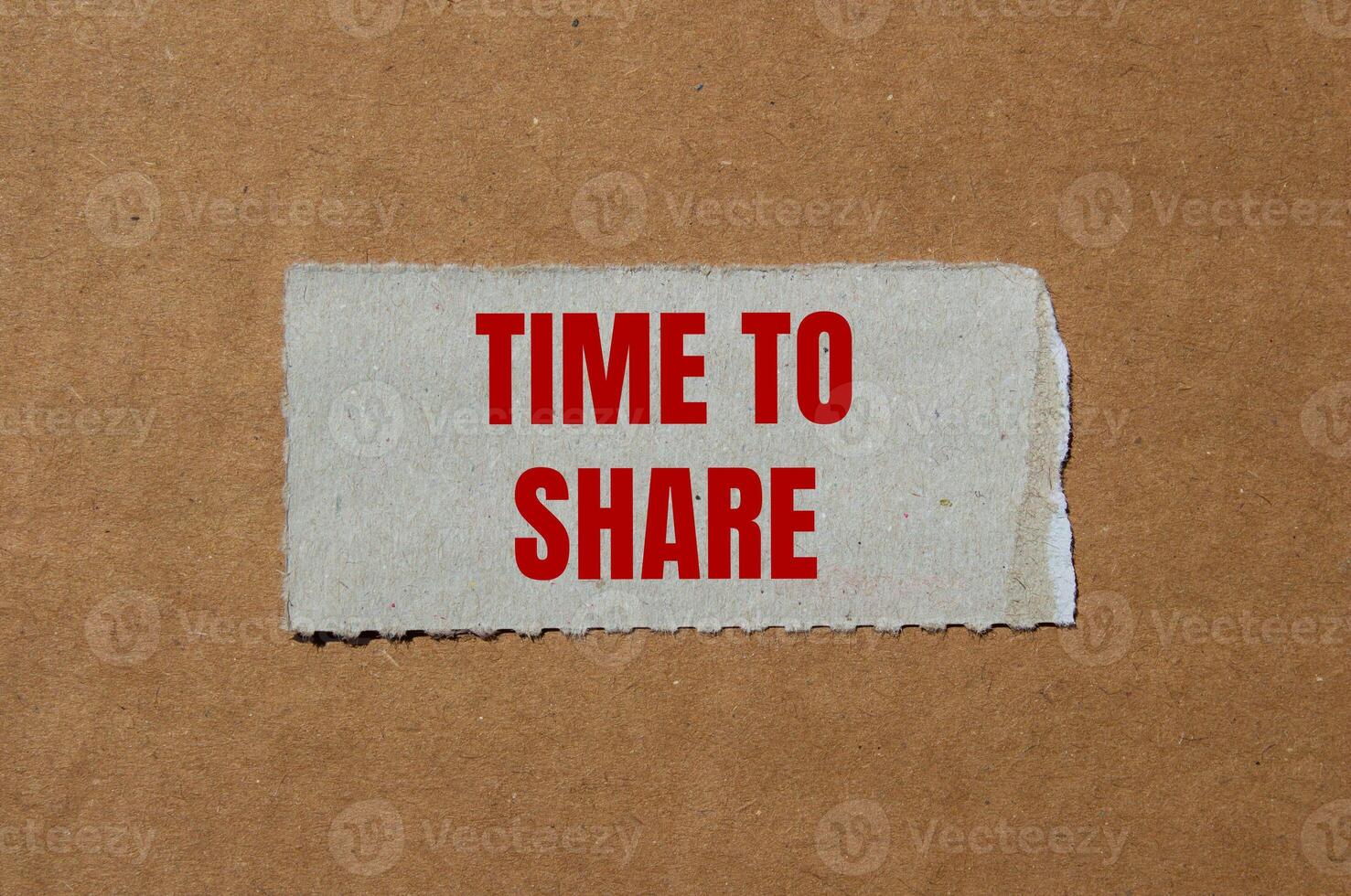 Time to share message written on ripped torn paper piece with cardboard background. Conceptual time to share symbol. Copy space. photo