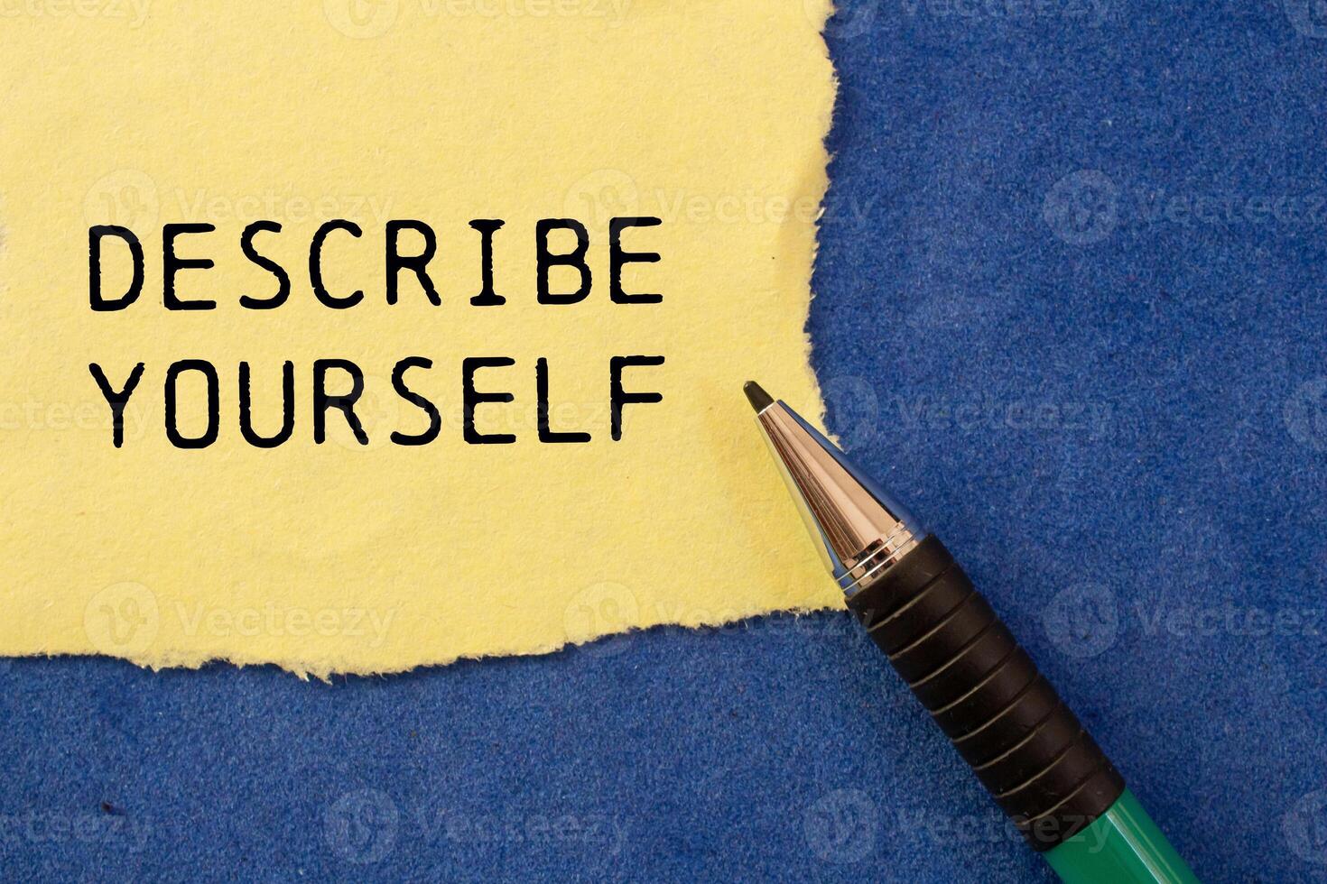 Describe yourself message written on ripped torn yellow paper with a pen on blue background. Conceptual describe yourself symbol. Copy space. photo