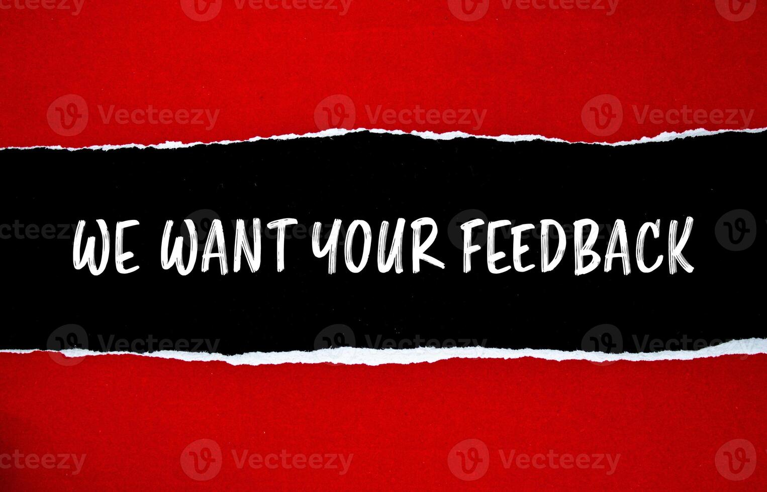 We want your feedback message written on ripped torn red paper with black background. Conceptual we want your feedback symbol. Copy space. photo