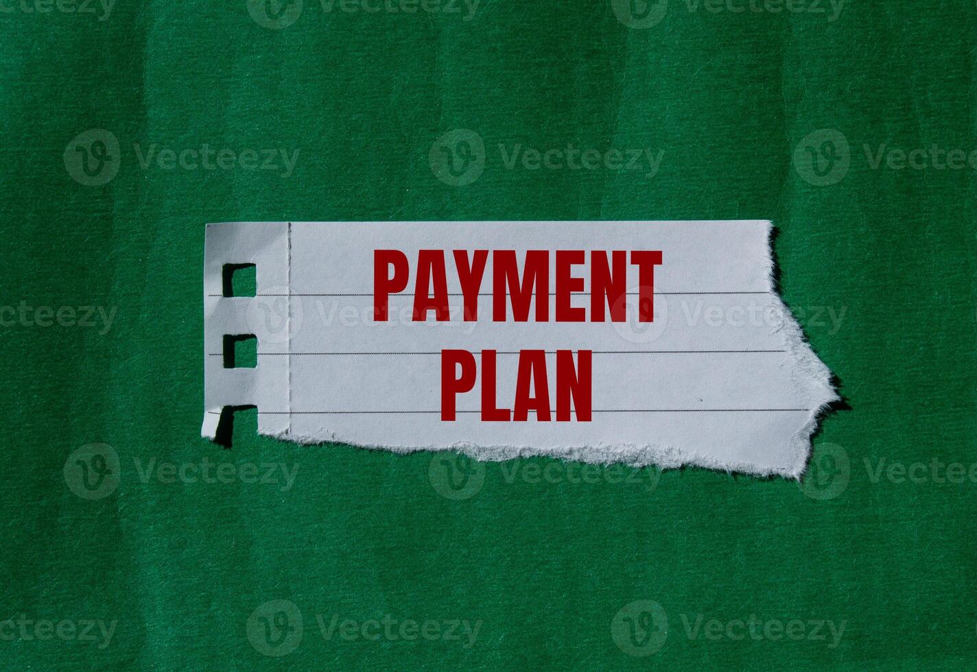 Payment plan message written on ripped torn paper with green background. Conceptual payment plan symbol. Copy space. photo