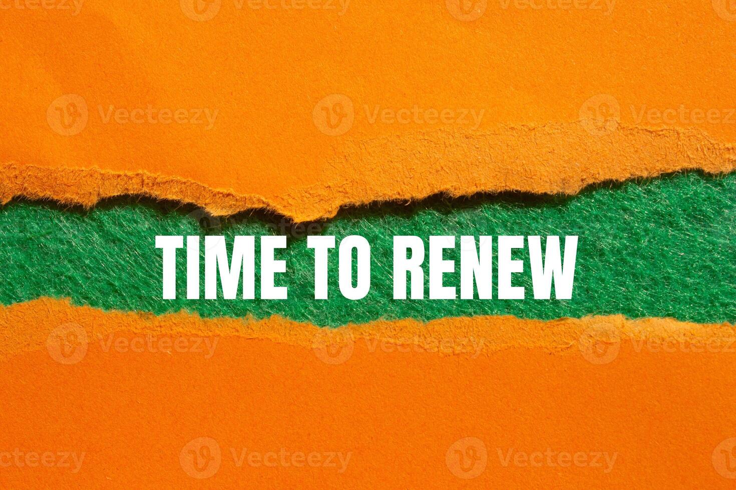 Time to renew message written on ripped torn orange paper with green background. Conceptual time to renew symbol. Copy space. photo