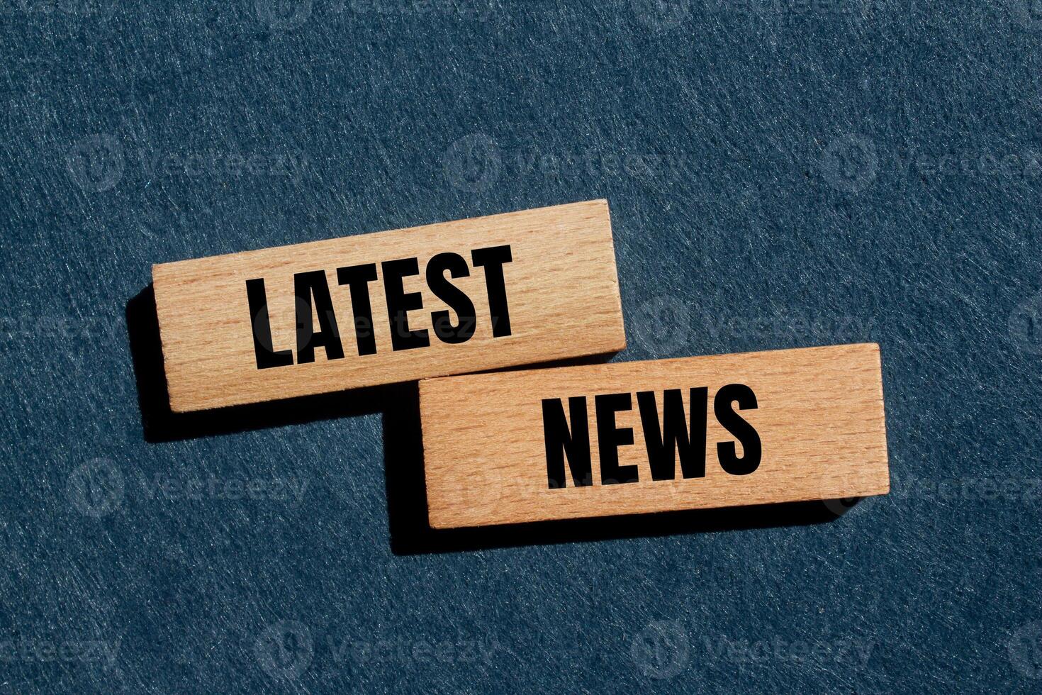 Latest news message written on wooden blocks with gray background. Conceptual latest news symbol. Copy space. photo