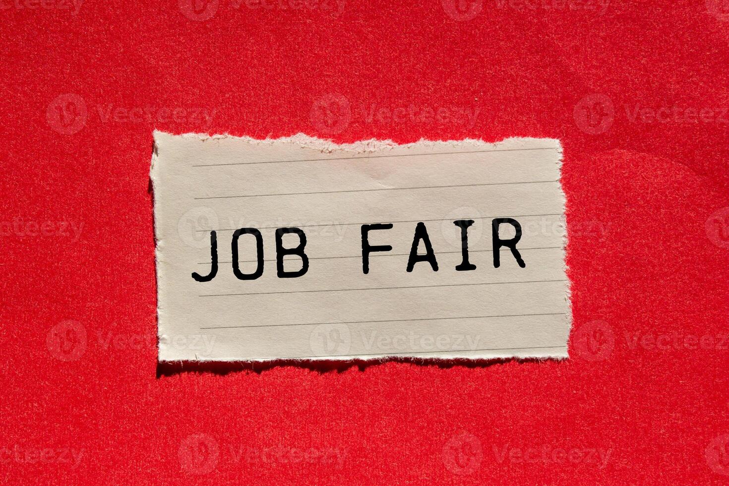 Job fair message written on ripped torn paper piece on red background. Conceptual job fair symbol. Copy space. photo