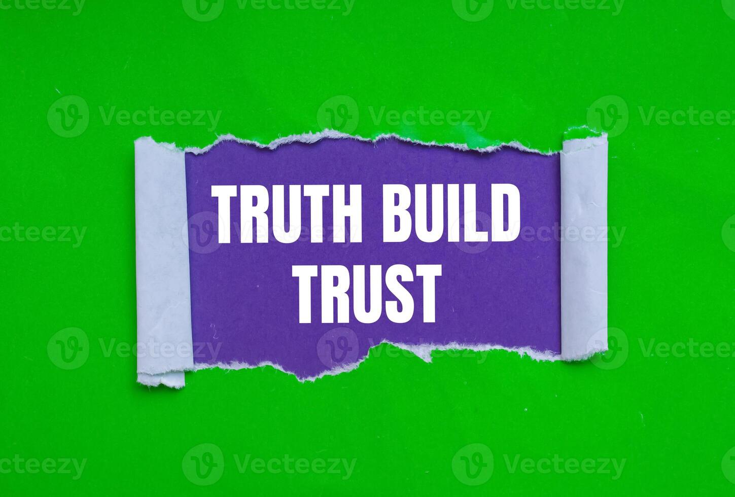 Truth build trust message written on ripped torn green paper on purple background. Conceptual truth build trust symbol. Copy space. photo
