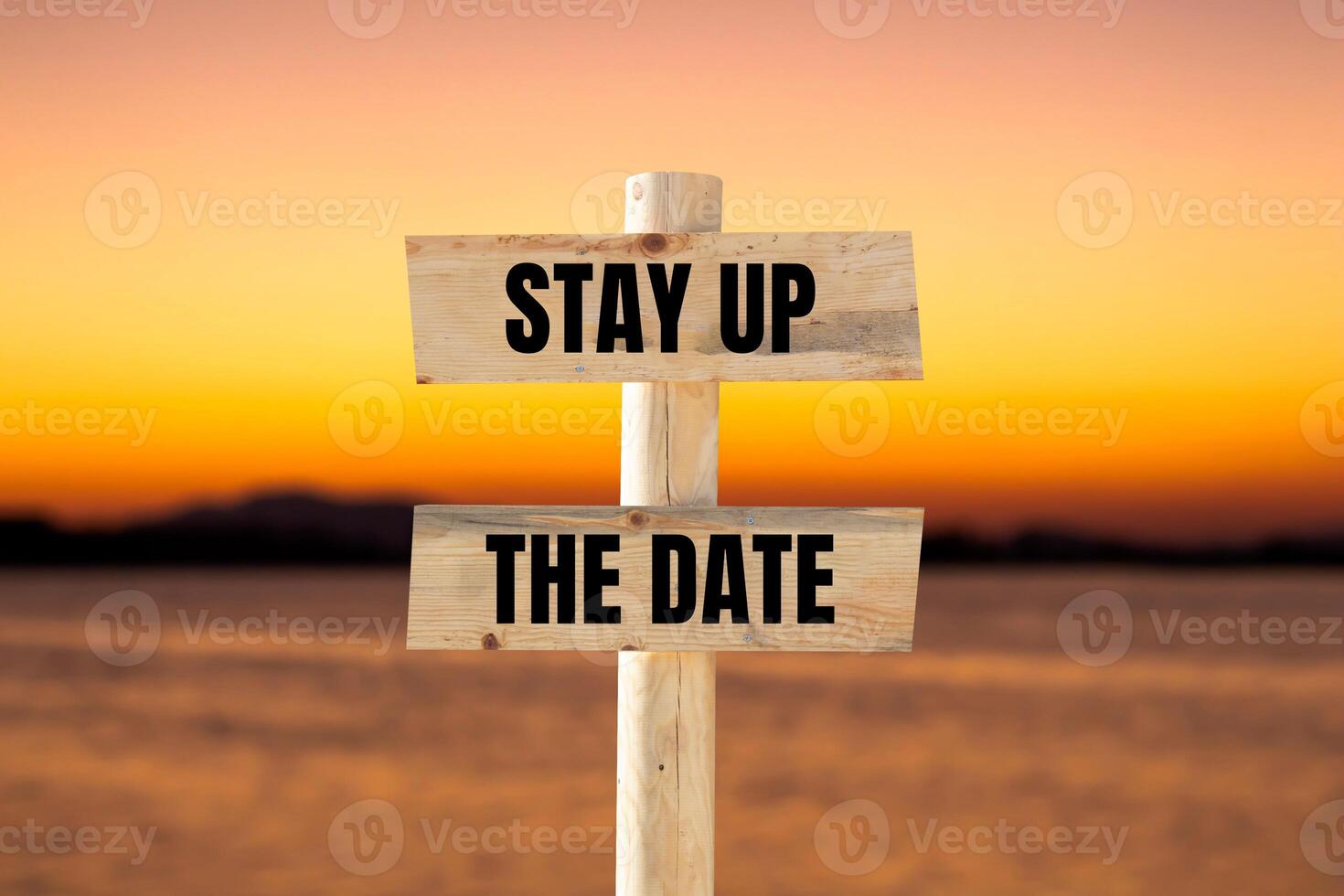 Stay up the date message written on wooden sign with blurry lake background. Conceptual stay up the date symbol. Copy space. photo