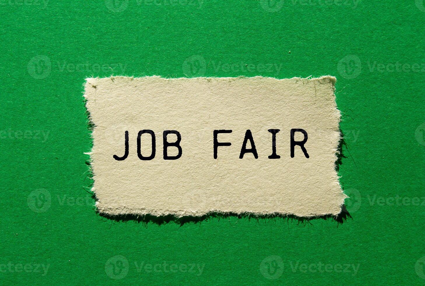 Job fair message written on ripped torn paper piece on green background. Conceptual job fair symbol. Copy space. photo