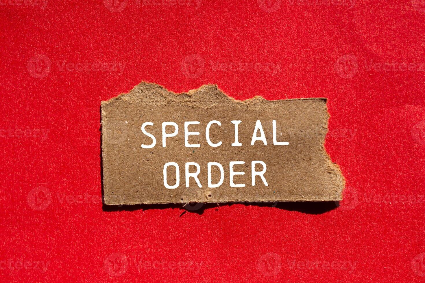 Special order message written on ripped torn brown paper piece on red background. Conceptual special order symbol. Copy space. photo