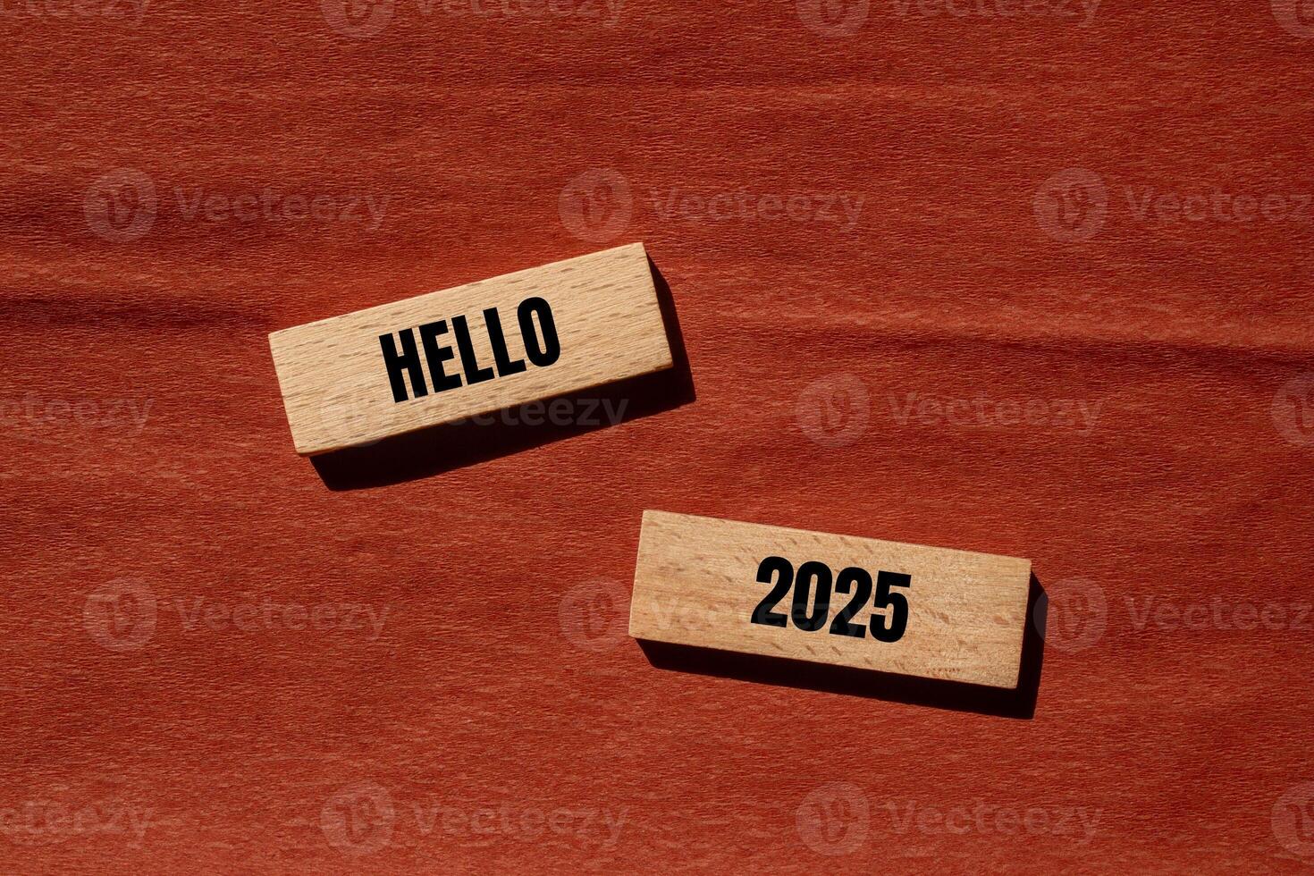 Hello 2025 message written on wooden blocks with brown background. Conceptual hello 2025 symbol. Copy space. photo