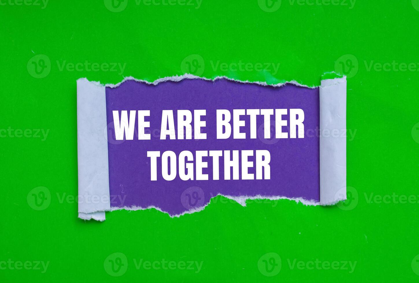 We are better together message written on ripped torn green paper on purple background. Conceptual we are better together symbol. Copy space. photo