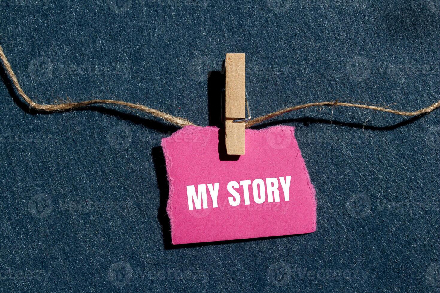 My story message written on ripped torn pink paper piece with gray background. Conceptual my story symbol. Copy space. photo