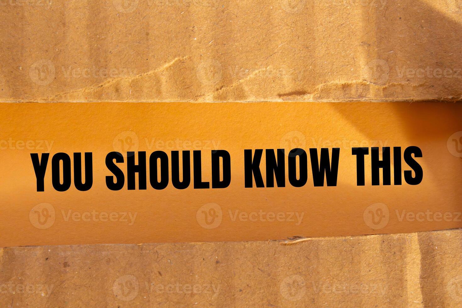 You should know this message written on ripped torn cardboard paper with orange background. Conceptual you should know this symbol. Copy space. photo