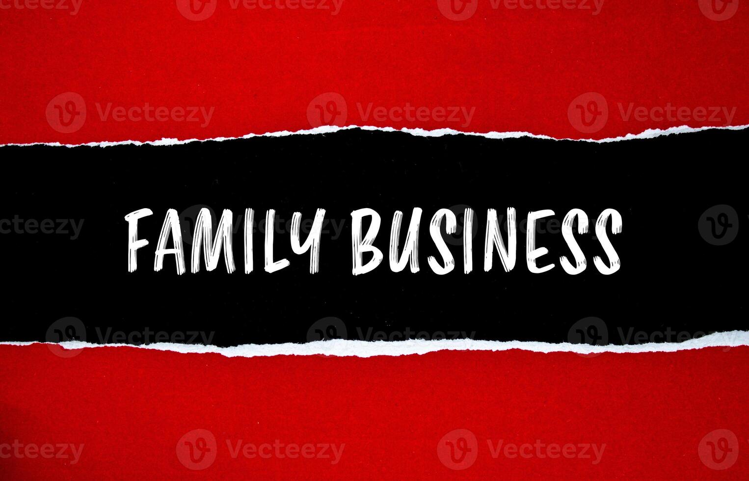 Family business message written on ripped torn red paper with black background. Conceptual family business symbol. Copy space. photo