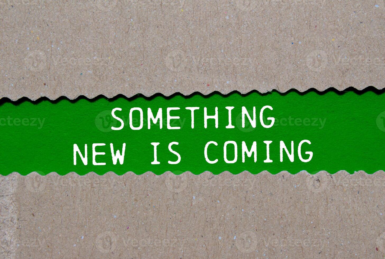 Something new is coming message written on ripped torn paper on green background. Conceptual something new is coming symbol. Copy space. photo