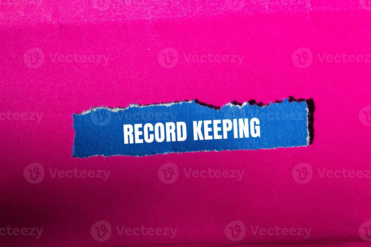 Record keeping message written on ripped torn blue paper piece with pink background. Conceptual record keeping symbol. Copy space. photo