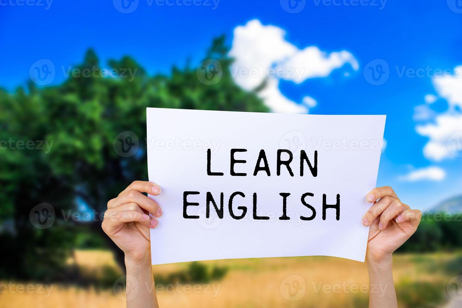 Learn english message written on white paper with nature background. Conceptual learn english symbol. Copy space. photo