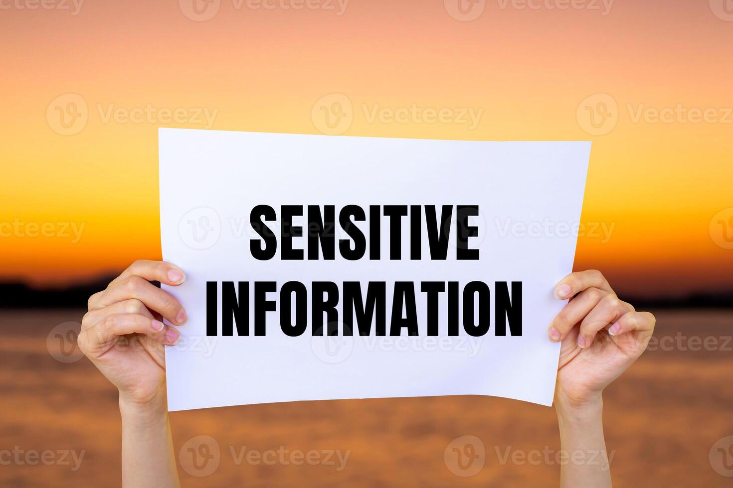 Sensitive information message written on white paper with blurry lake background. Conceptual sensitive information symbol. Copy space. photo