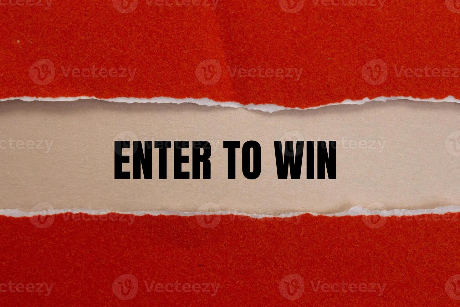 Enter to win message written on ripped red torn paper with beige background. Conceptual enter to win symbol. Copy space. photo