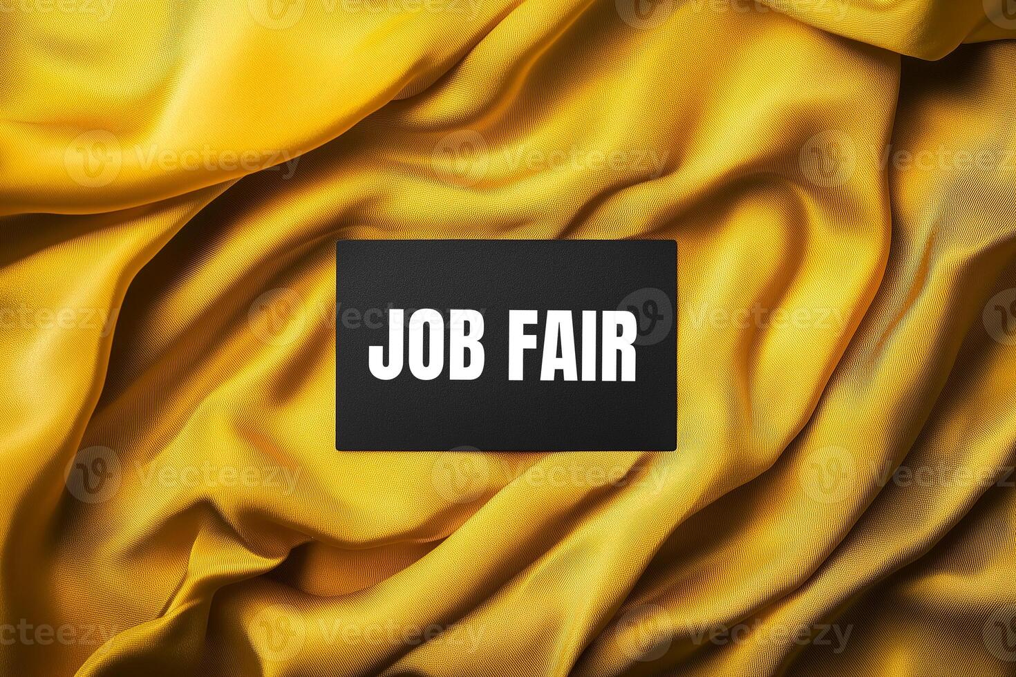 Job fair message written on black card with yellow fabric background photo