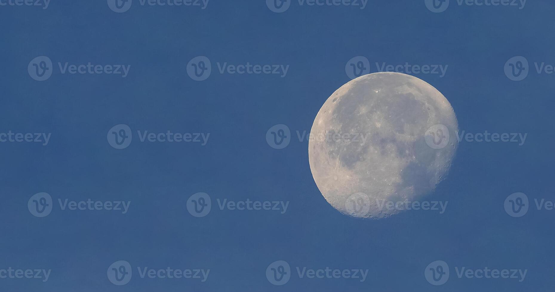 Full moon over blue sky photo