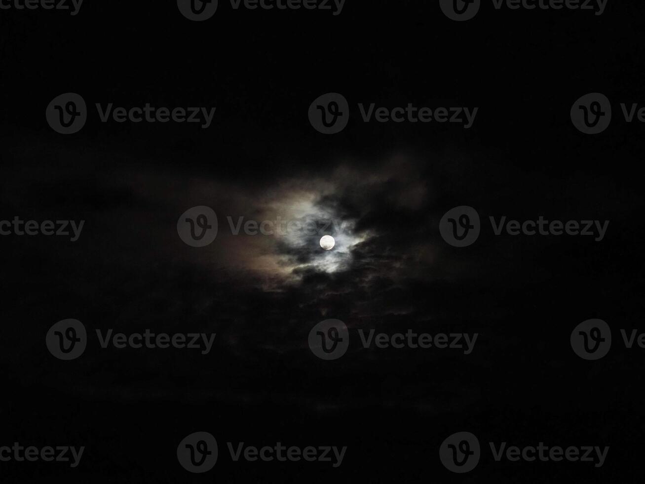 moon behind clouds photo