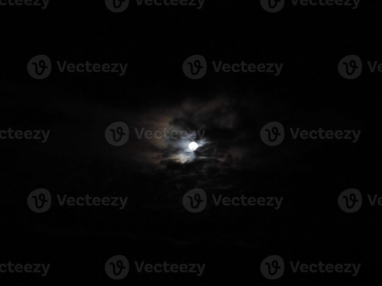 moon behind clouds photo