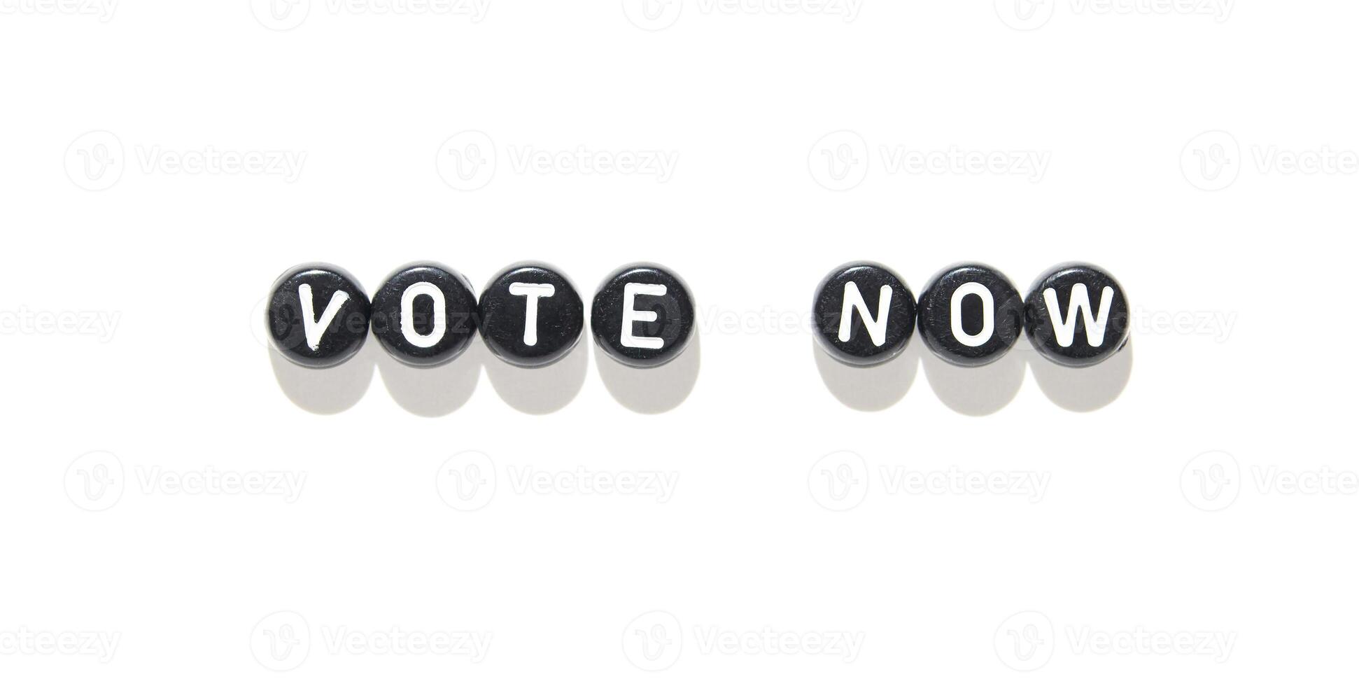 Vote now message in black and white beads on white background for election awareness. photo