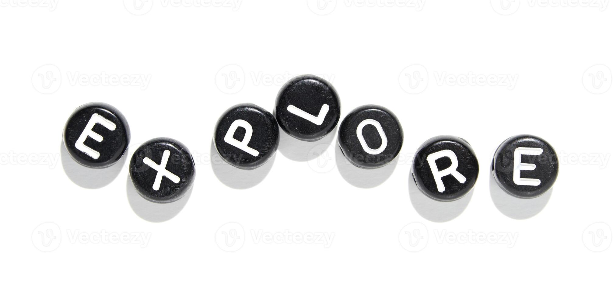 Explore concept using alphabet beads on white background for creativity and learning photo