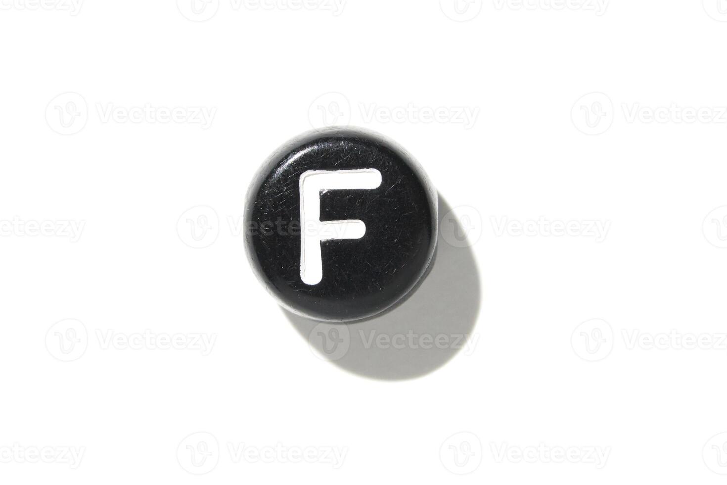 Single black keyboard key with letter f on white background for minimalist tech design aesthetic photo