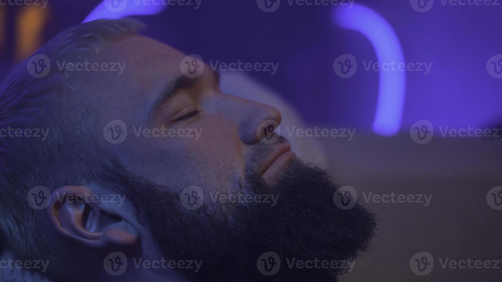 Man lies on the couch and looks up photo