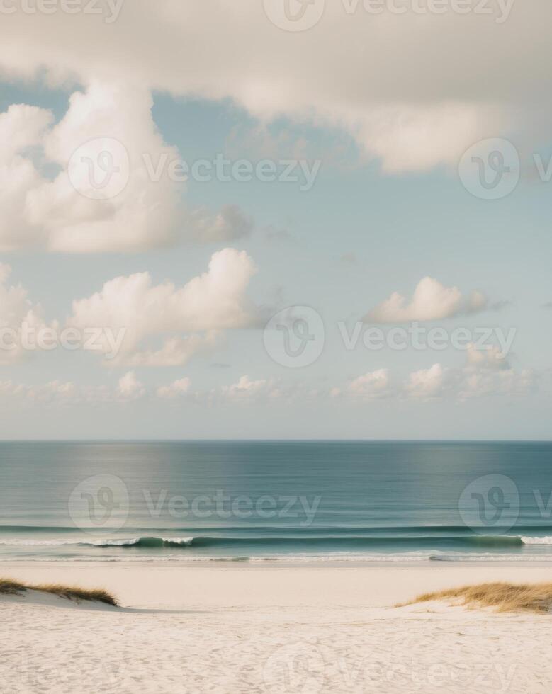A beach with a surfboard and a person standing on the sand photo