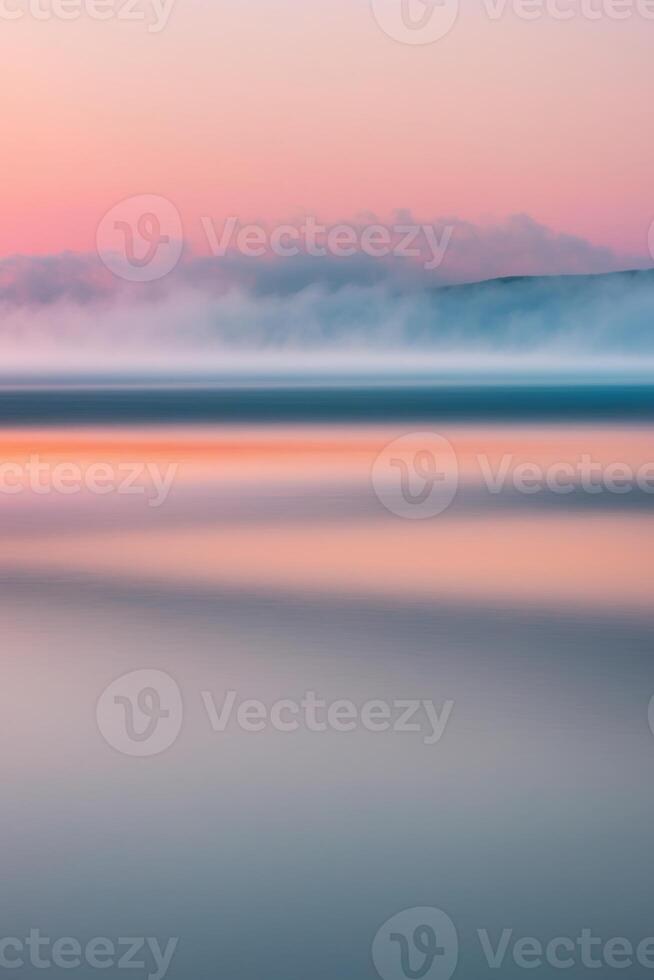 A long exposure photograph of the ocean at sunset photo