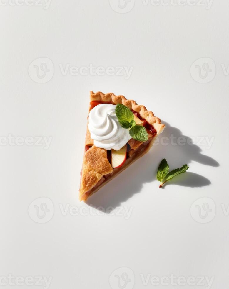 A slice of apple pie with whipped cream and mint leaves photo