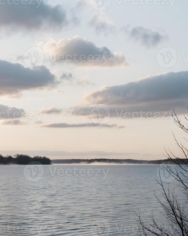 Serene Dawn Over Lake with Low Hanging Clouds. photo