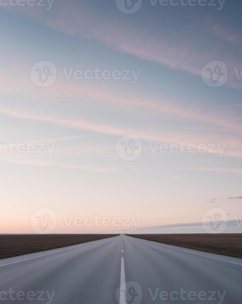 An empty road in the middle of a field photo