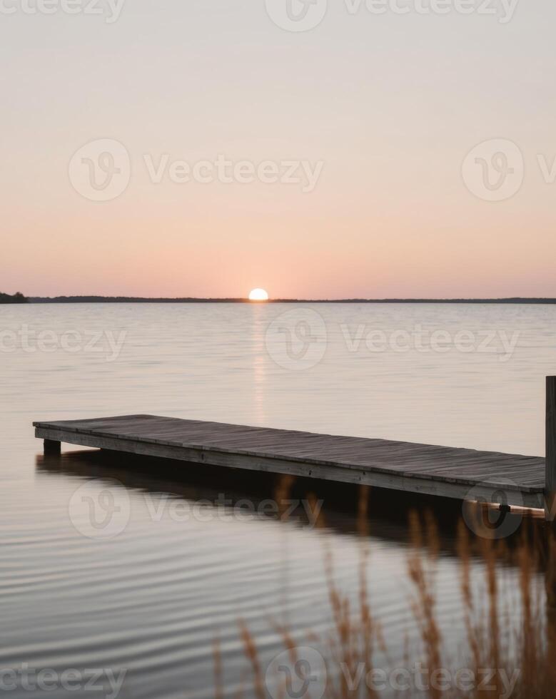 A dock in the water at sunset photo