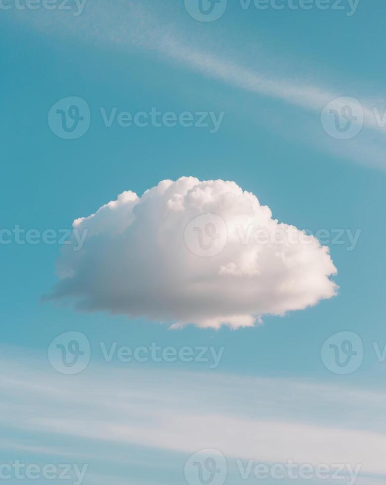 A cloud is floating in the sky above a field photo