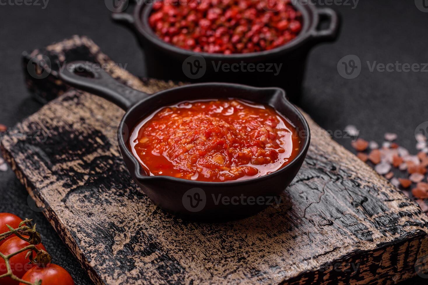 Delicious hot spicy red sauce with salt and spices in a ceramic bowl photo