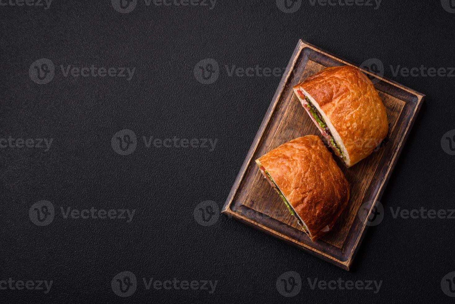 Ciabata with jamon or prosciutto, tomatoes, cheese and lettuce photo